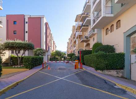 Modern apartment with communal swimming pool and parking space.5